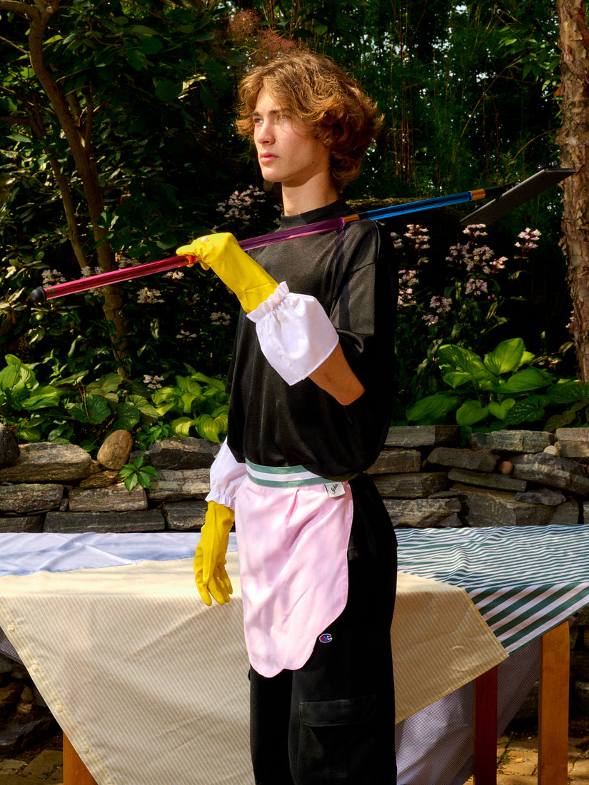 Someone wears Gohar World Host Gloves and the Striped & Scalloped Apron while holding a Staff Mop over their shoulder.