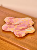 Marbled pink and yellow lazy susan on a wooden surface