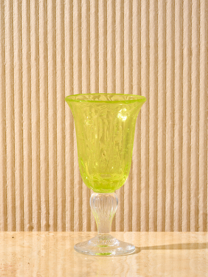 A yellow Bubbled Wine Glass by La Romaine Editions.