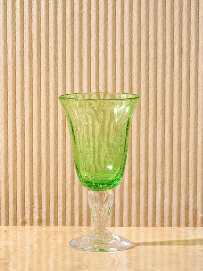 A green Bubbled Wine Glass by La Romaine Editions.