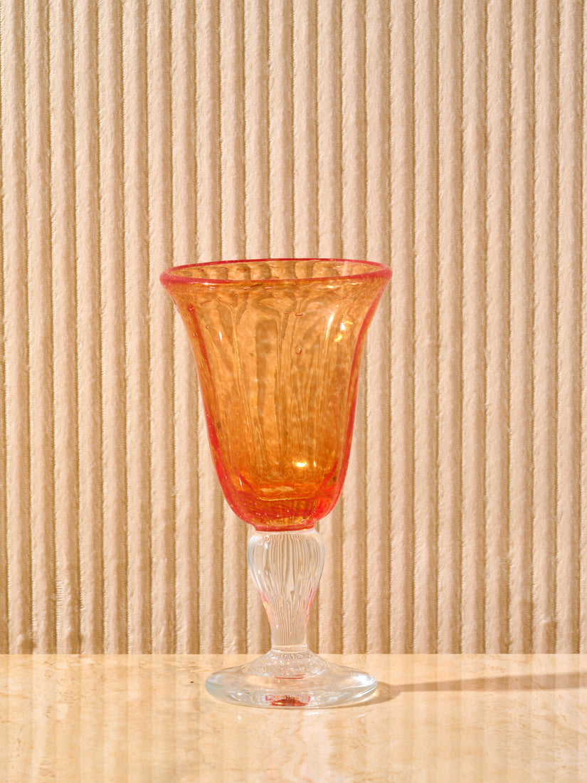 An orange Bubbled Wine Glass by La Romaine Editions.