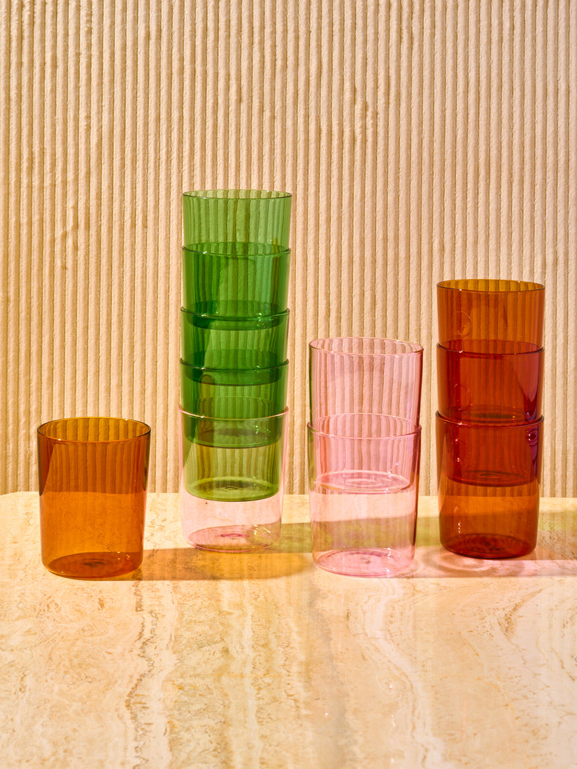 Stacks of green, amber, and pink large goblets by Maison Balzac.