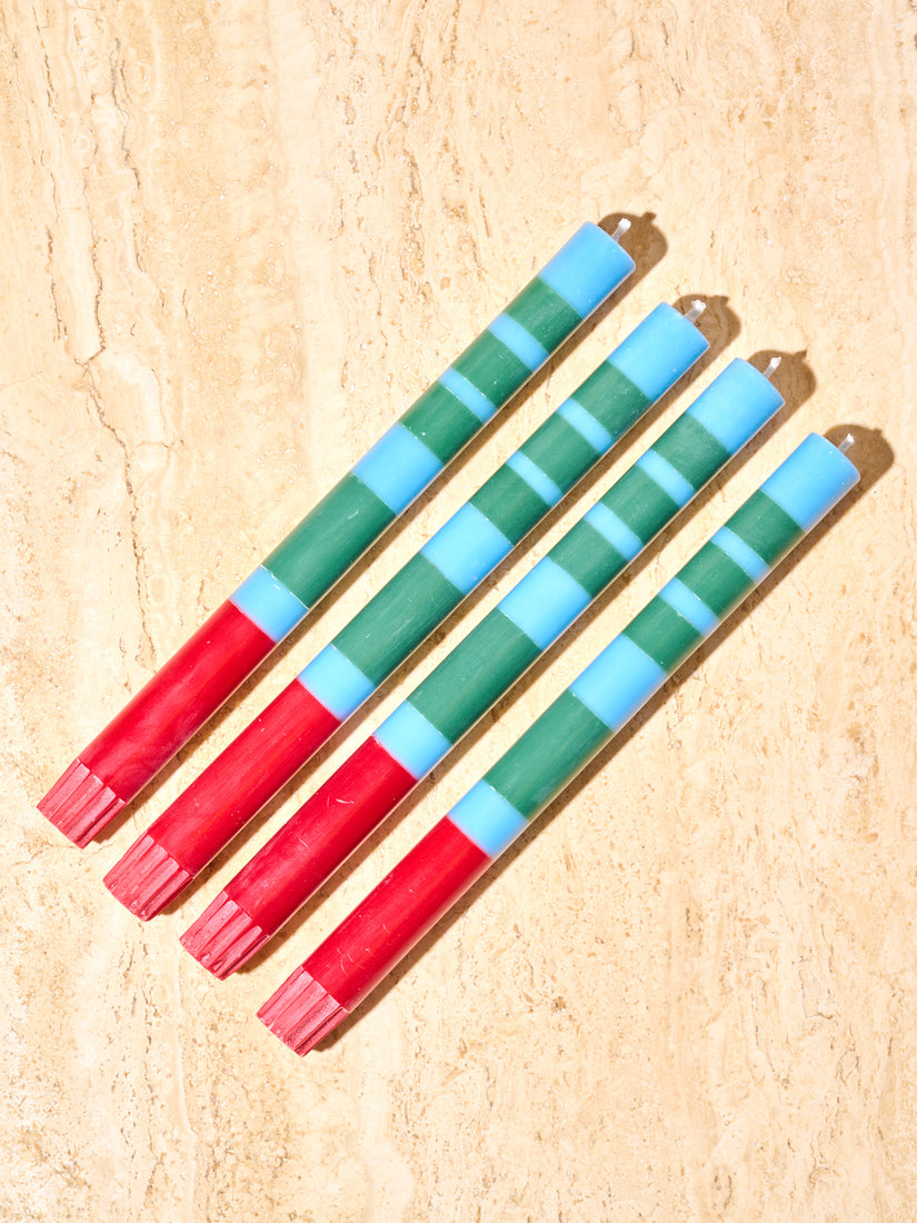 Four blue, green, and red taper candles by British Colour Standard.