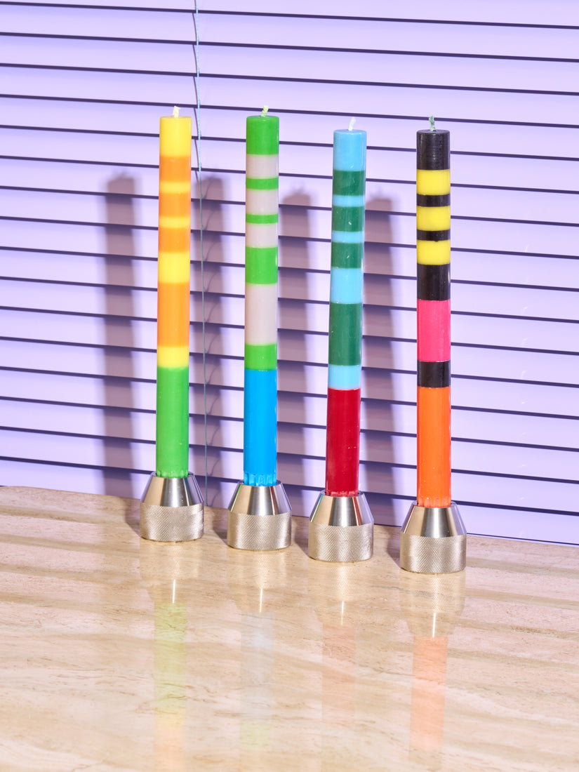 Taper Candles by British Colour Standard in 4 colorways, all sitting in Drill Bit Candle Holders by 54 Celcius.