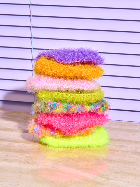 A stack of 8 sponges by Sponge NYC in different colors.