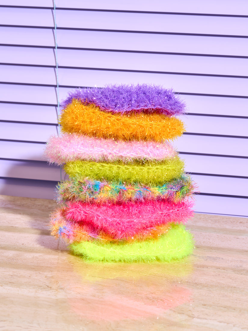 A stack of 8 sponges by Sponge NYC in different colors.