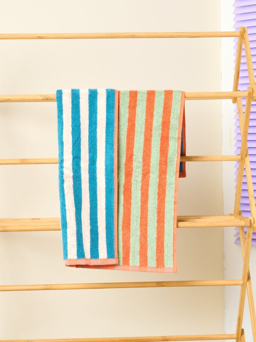 Sunset Hand Towel by Dusen Dusen with orange and sage stripes on one side, blue and white on the other.