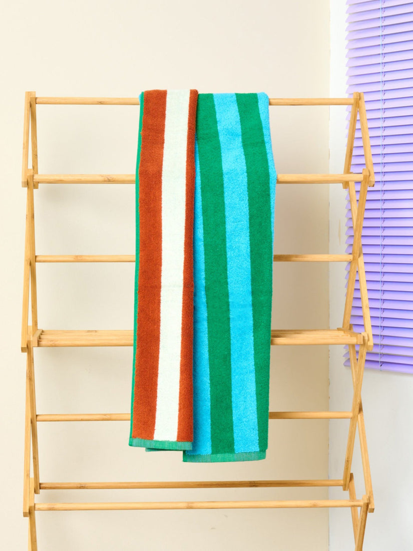 Field Bath Towel by Dusen Dusen with green and blue stripes on one side, brown and white on the other.