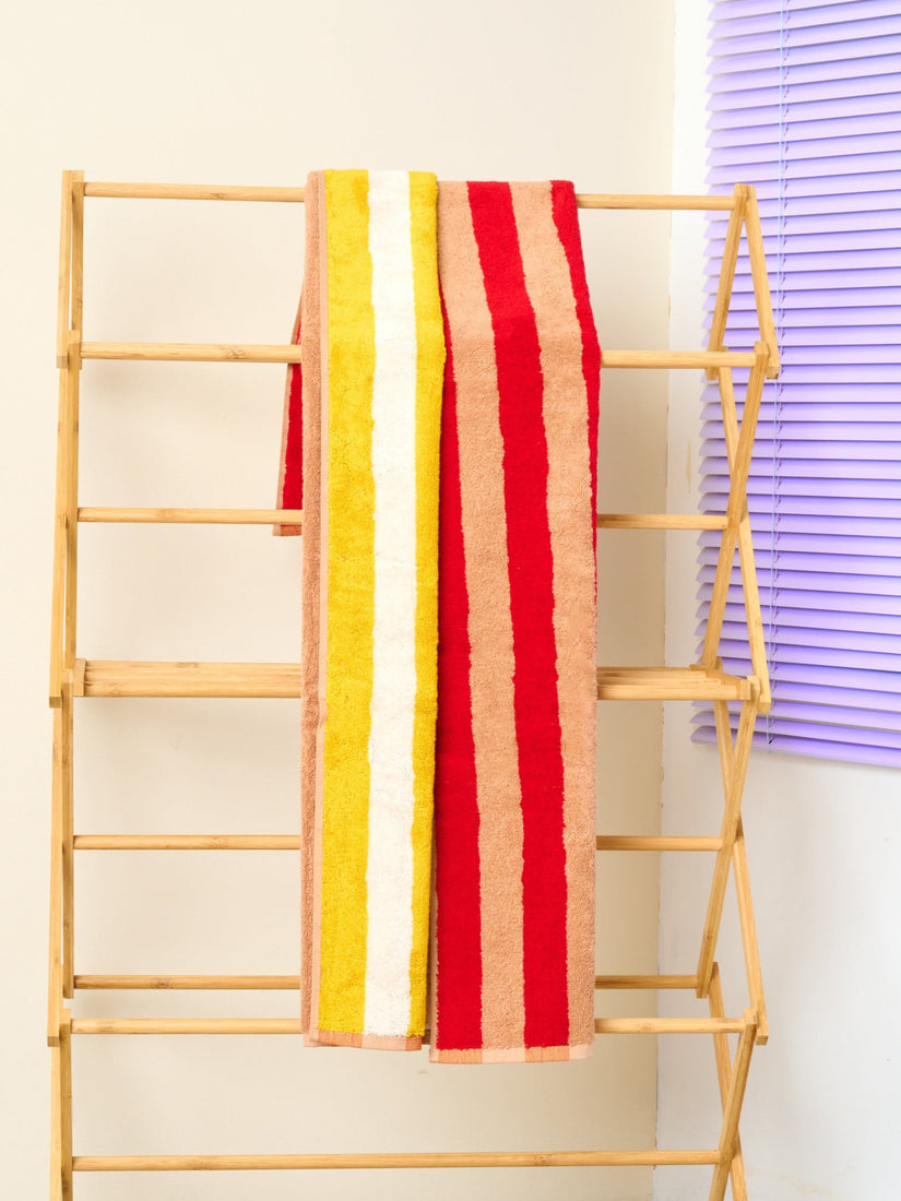 Desert Bath Towel by Dusen Dusen wtih red and beige stripes on one side, yellow and white on the other.