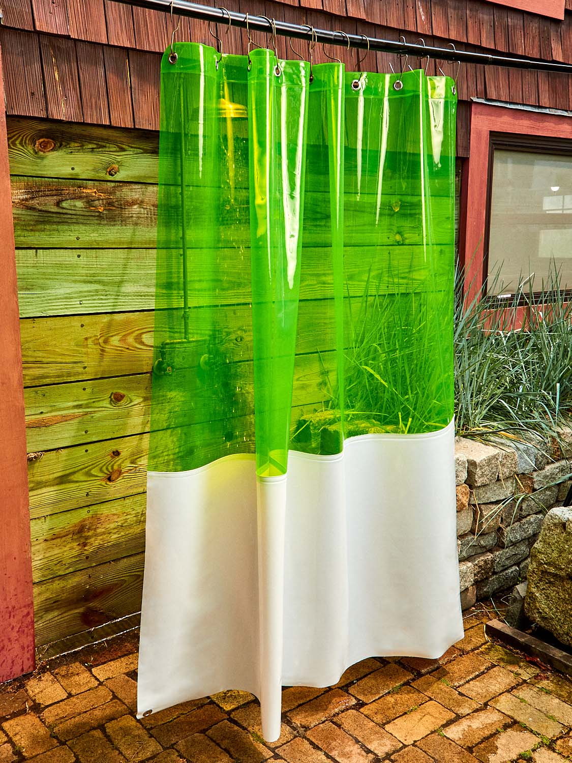 The Zinc Sun Shower Curtain hanging outside.