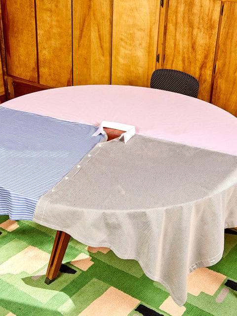 A round table wears the Shirt Tablecloth by Gohar World.