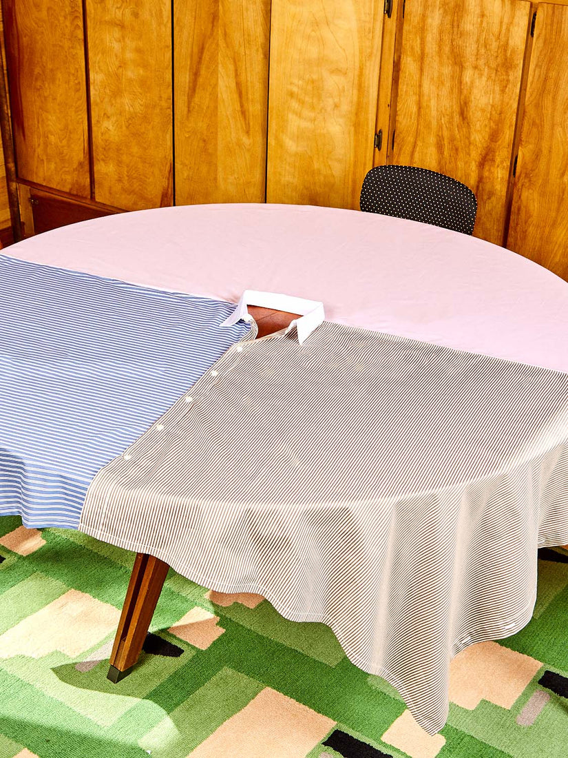 A round table wears the Shirt Tablecloth by Gohar World.