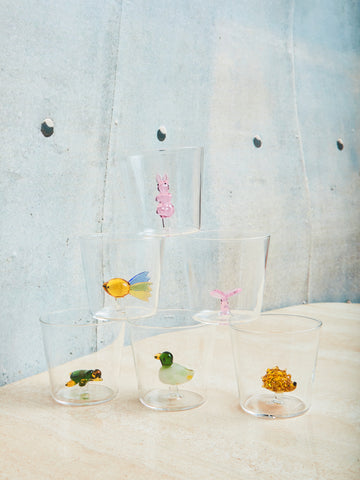 A set of six glass cups with figurines it on top of each other in a pyramid shape. On the bottom row there is a hedgehog, turtle, and duck glass figure in the glass cups. On the middle row there is a butterfly and fish glass figure. Lastly, on the top the