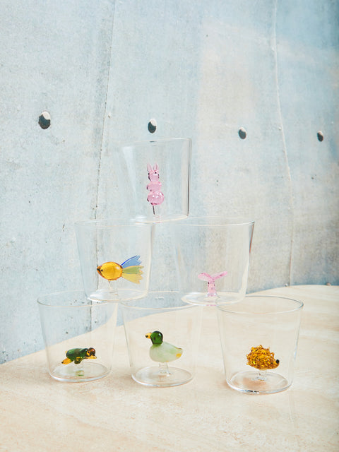 A set of six glass cups with figurines it on top of each other in a pyramid shape. On the bottom row there is a hedgehog, turtle, and duck glass figure in the glass cups. On the middle row there is a butterfly and fish glass figure. Lastly, on the top the