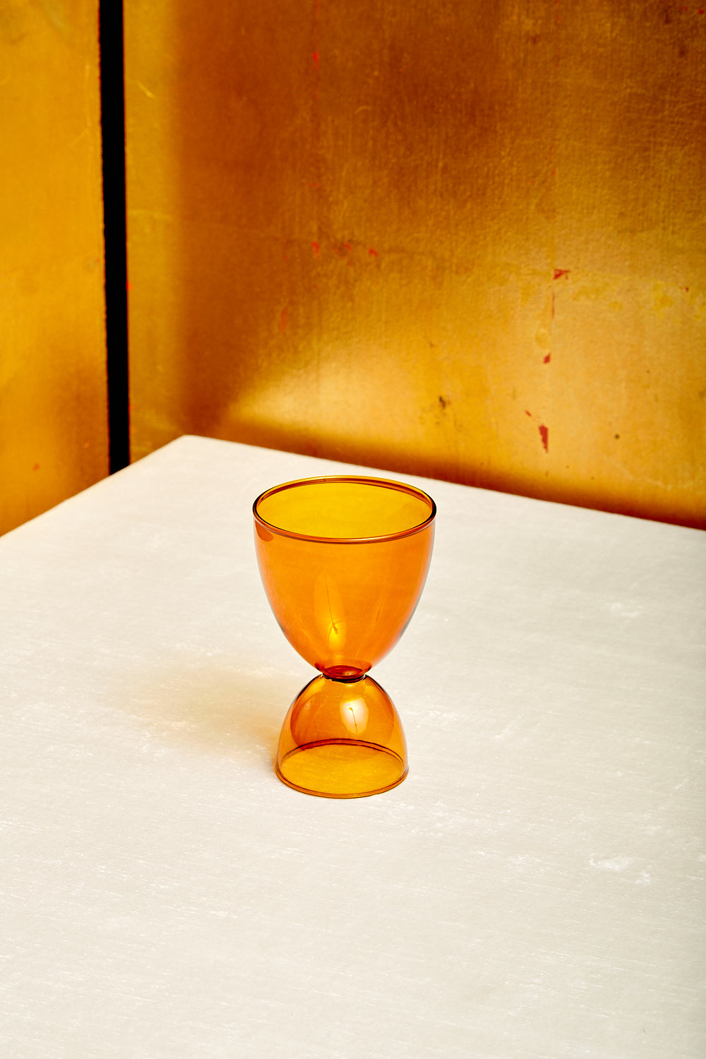 A single amber Cocktail Glass by Mamo.