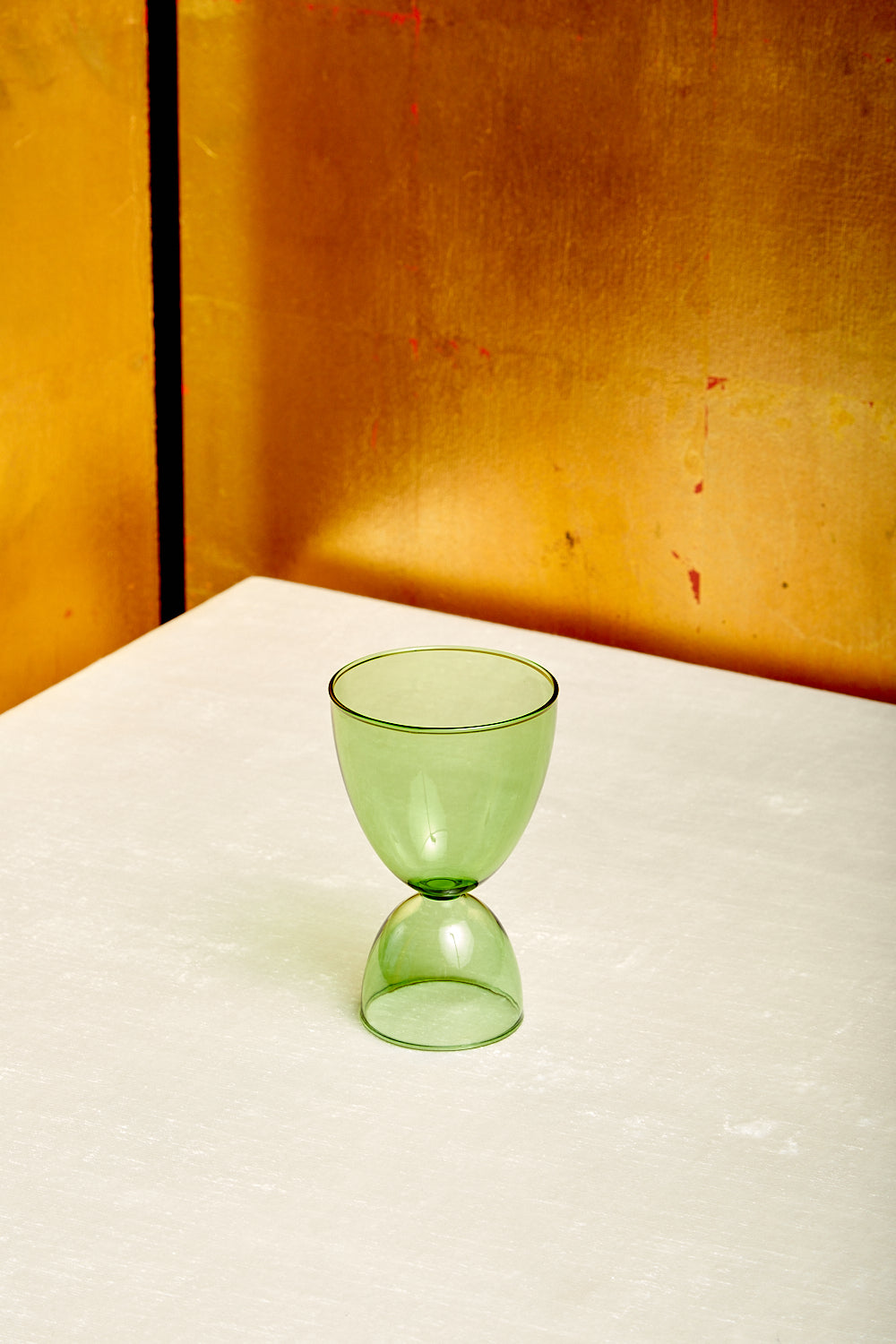 A single green cocktail glass by Mamo.