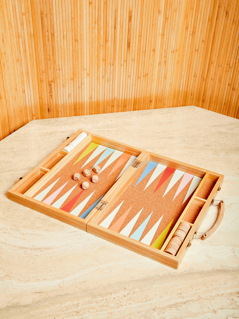 Sunnylife's Travel Backgammon opened displaying its colorful cork game board, wooden dice, and wooden game pieces.