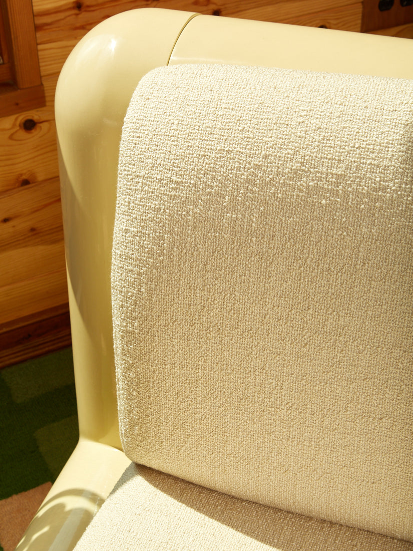Close up of the cream boucle upholstery.