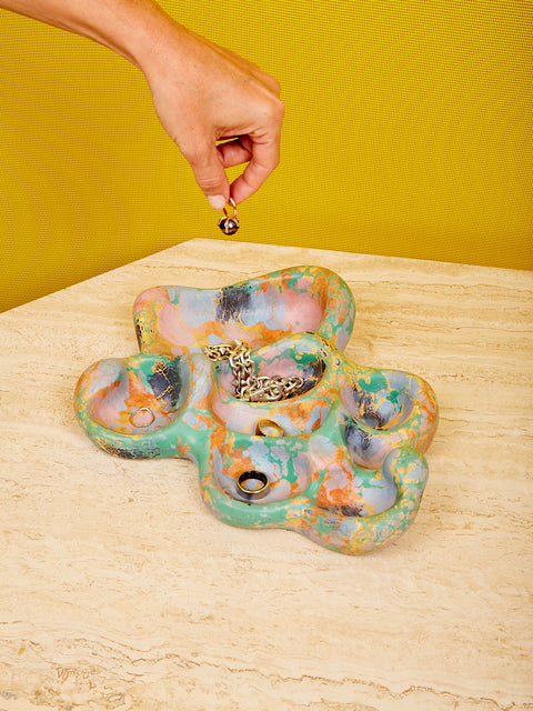 The Aphrodite Trinket Tray by Concrete Cat in the green and orange colorway full of jewelry.