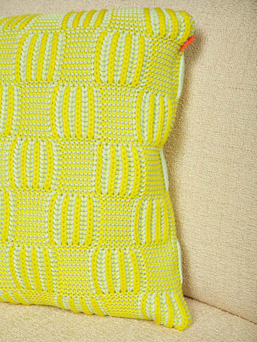 A close up of the knit pattern on the lime green chunky checkerboard pillow by Verloop.