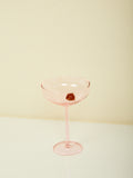 A pink Manhattan glass by Maison Balzac with pink glass cherry inside.