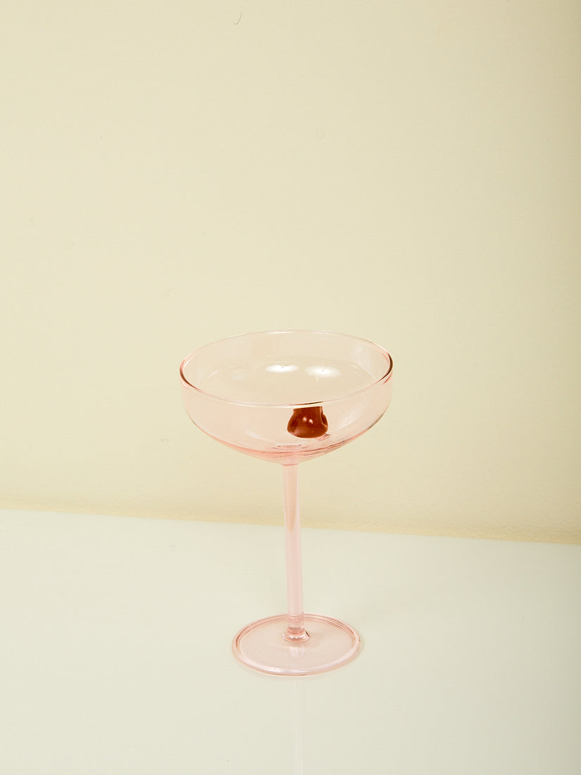 A pink Manhattan glass by Maison Balzac with pink glass cherry inside.