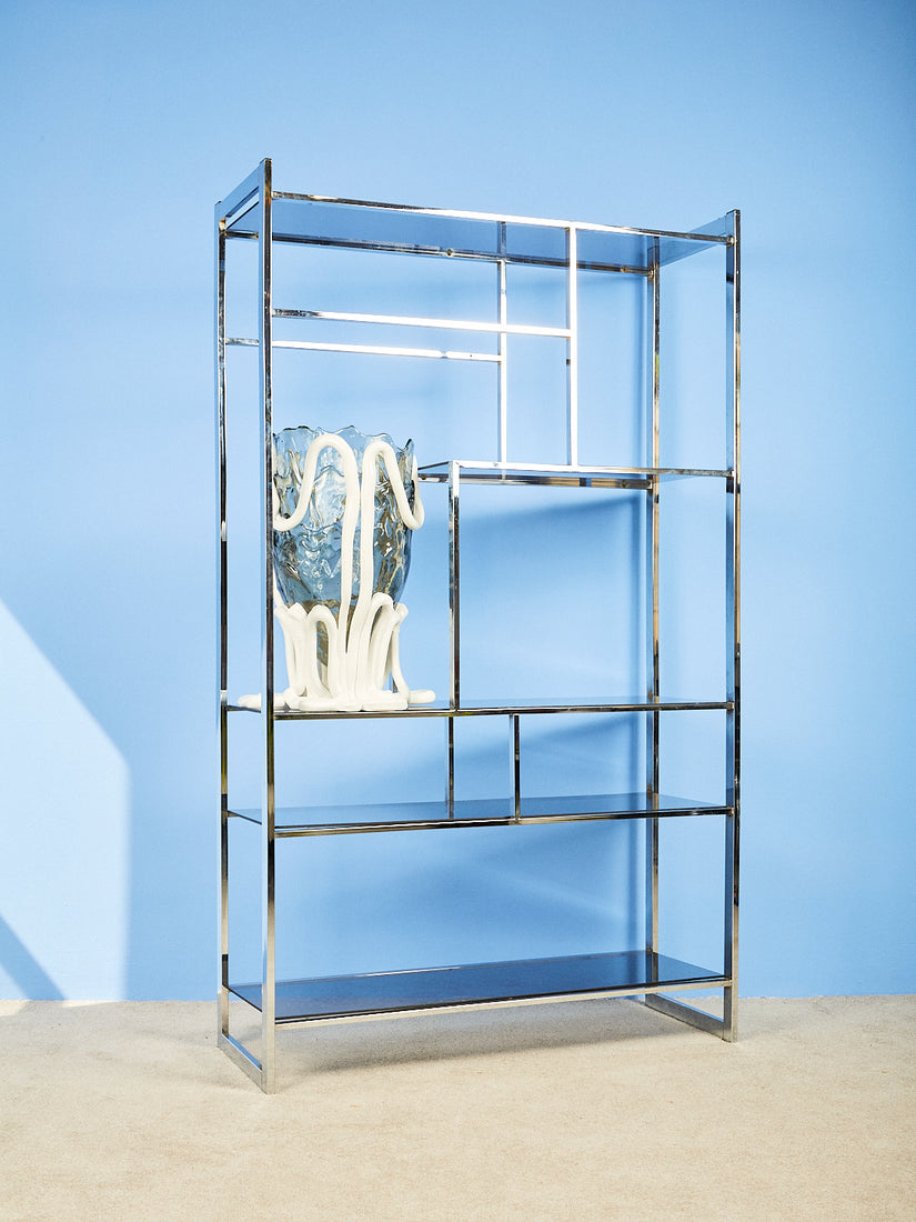 Chrome and Smoke Glass Etagere with asymmetrical shelves. An XXL Indian Summer Vessel sits on one of the shelves.