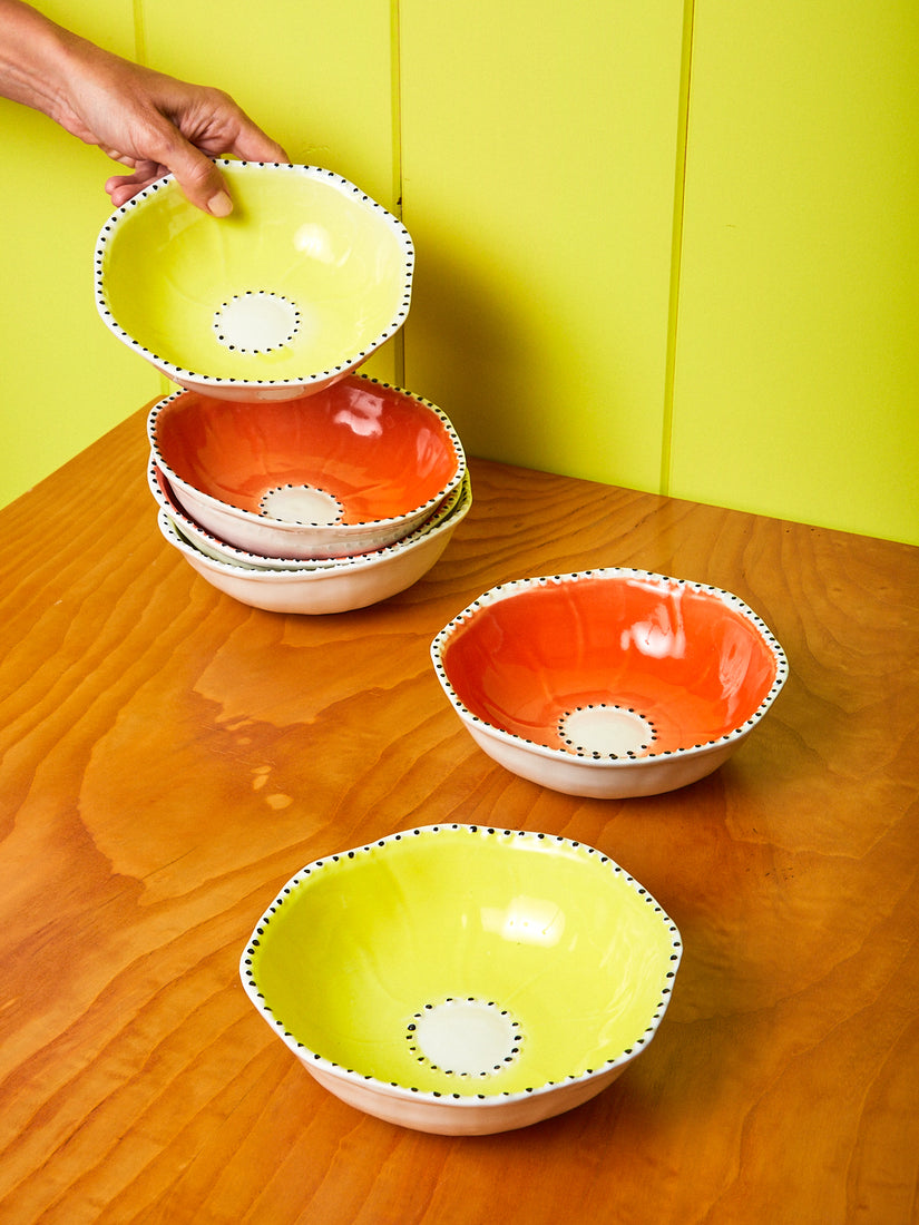 Orange and Yellow Poppy Bowls by La Romaine Editions stacked and displayed.
