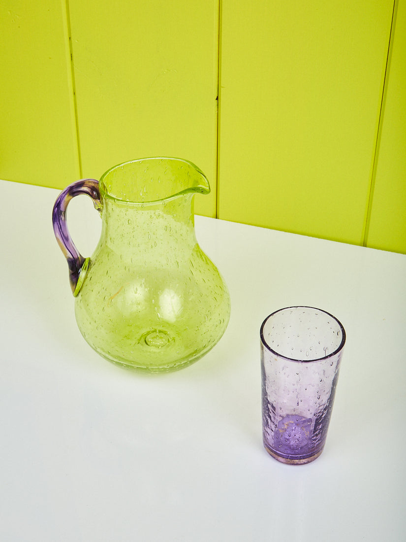 Bubble Glass Jug by La Romaine Editions next to a purple Orangeade Glass.