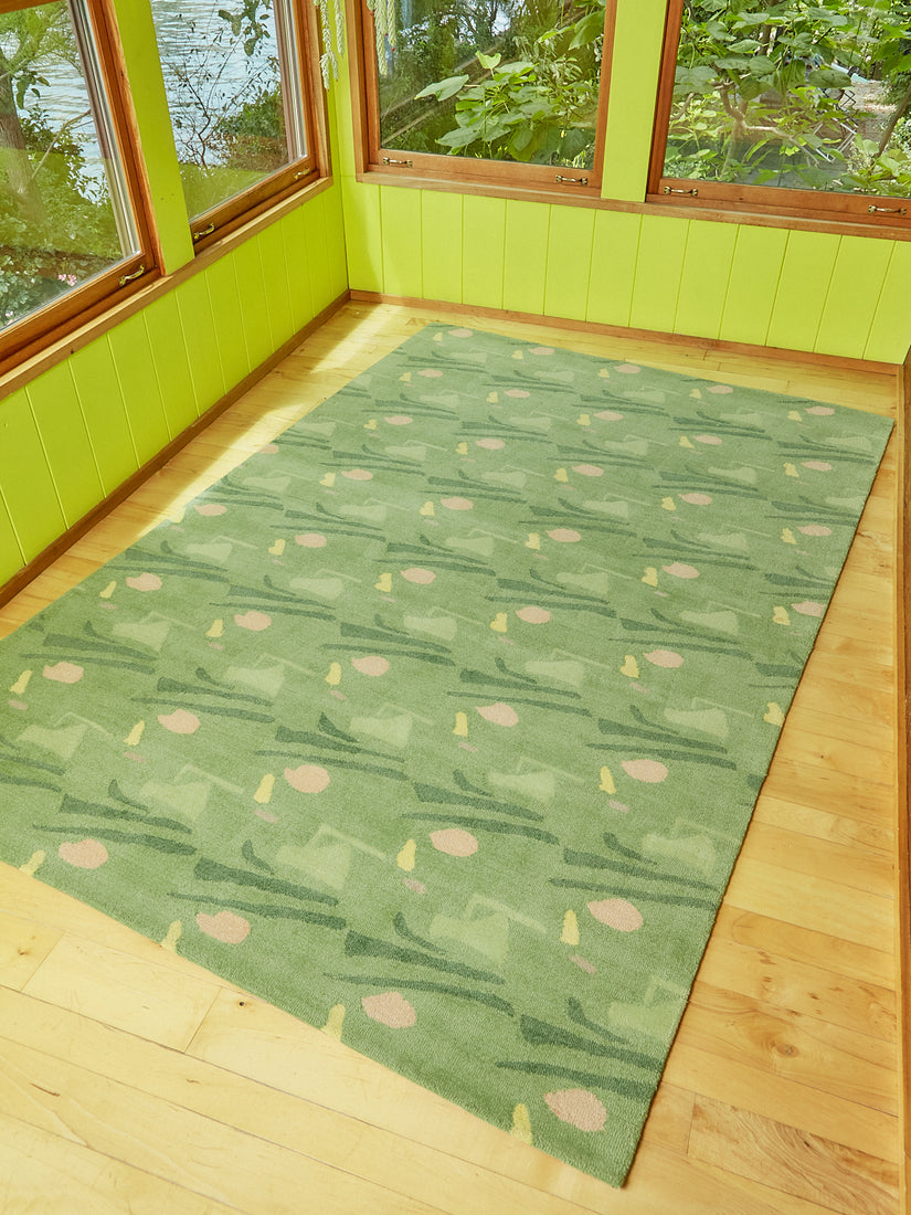 Sweetie Rug by Cold Picnic in a bright green sunroom full of windows.