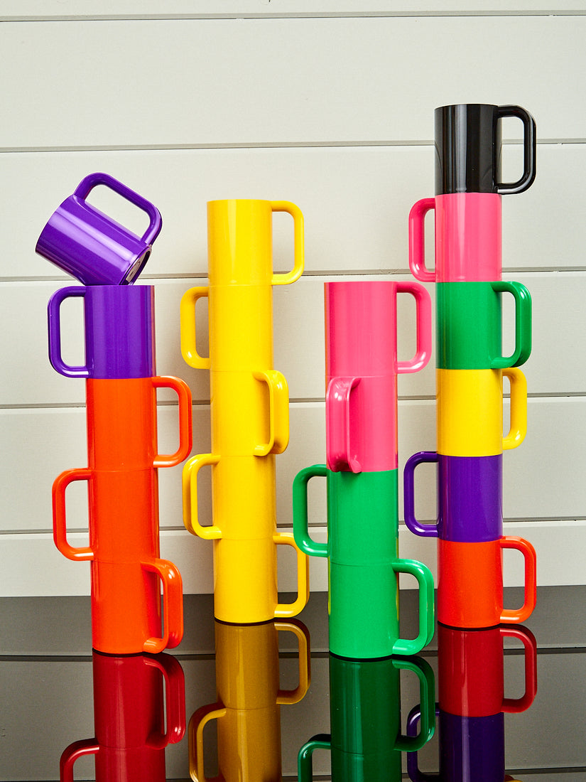 Four stacks of Max Mug's by Heller in various color ways.