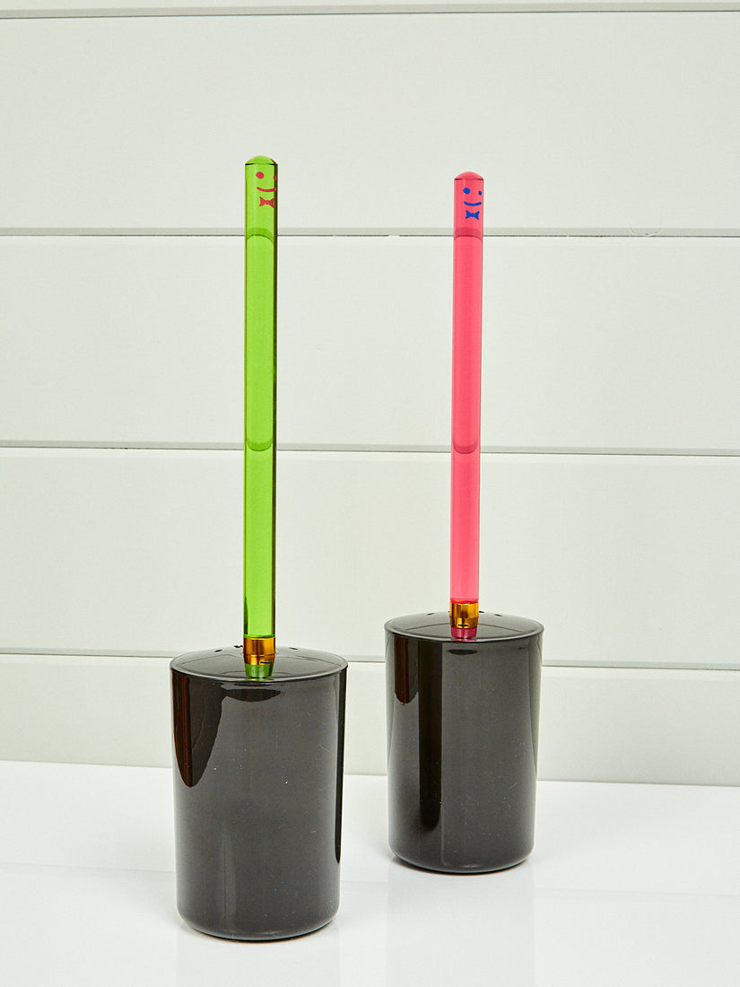 A pink and green Toilet Brush by Staff.