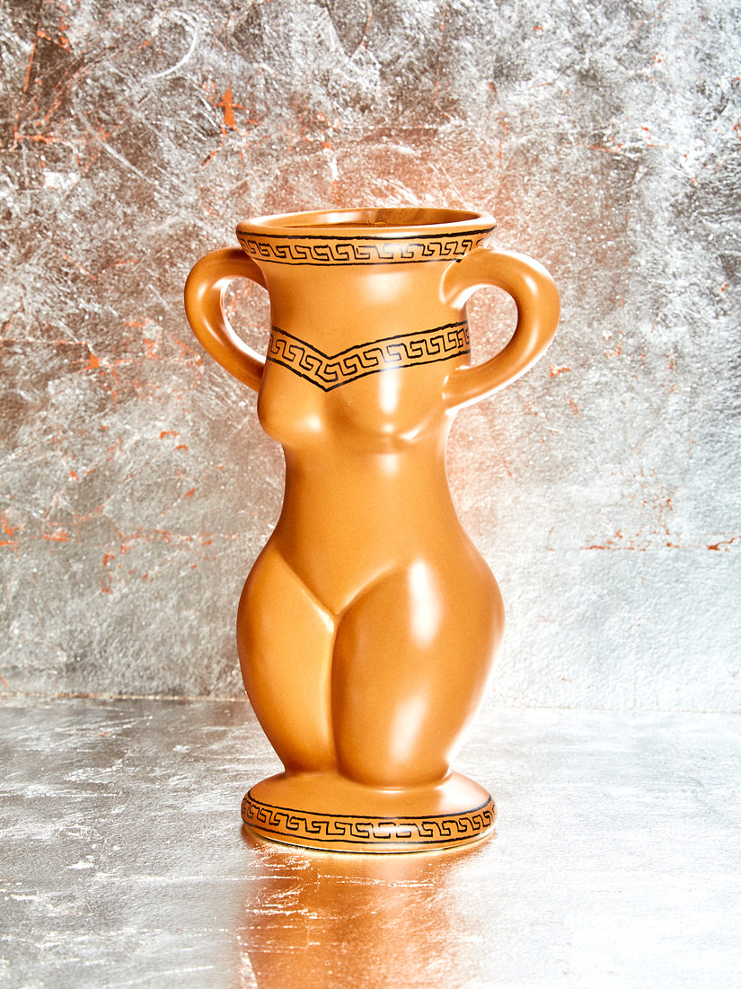 A ceramic vessel in the form of a feminine body that is also a candle.