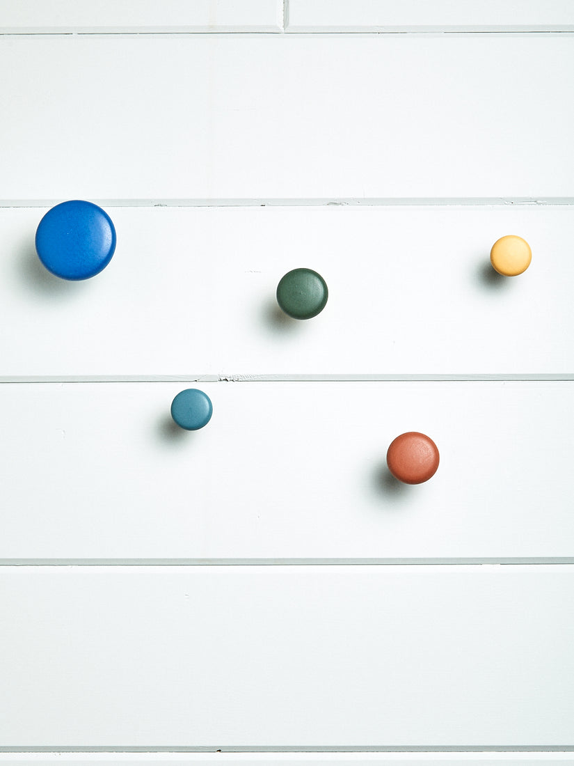 Harbor Wall Hooks by Pat Kim for Areware. 5 round wall hooks all with different colors.