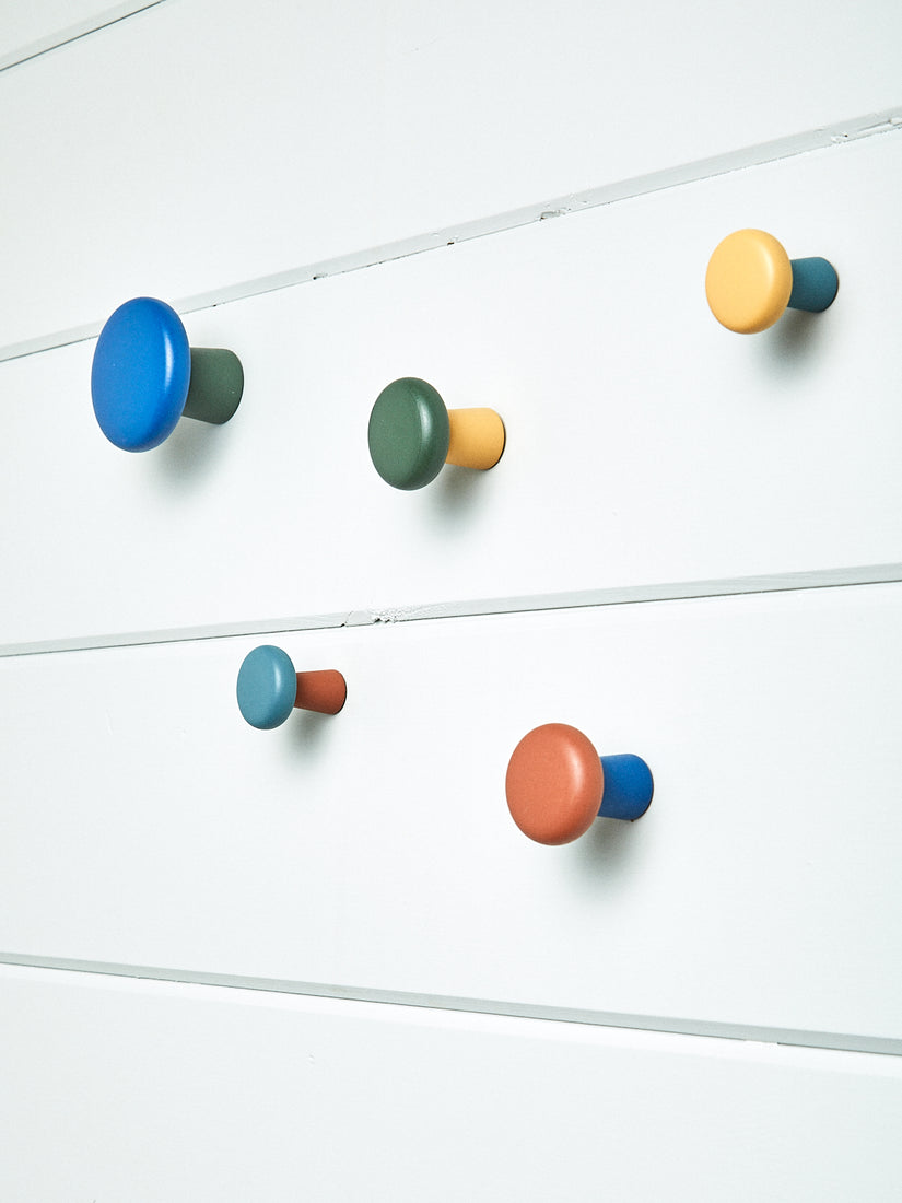Harbor Wall Hooks by Pat Kim for Areaware mounted to a white slatted wall.