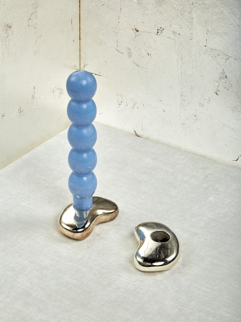 Two Bean Candle Holders by Gohar World. One candle holder has a Sky Volute Candle.