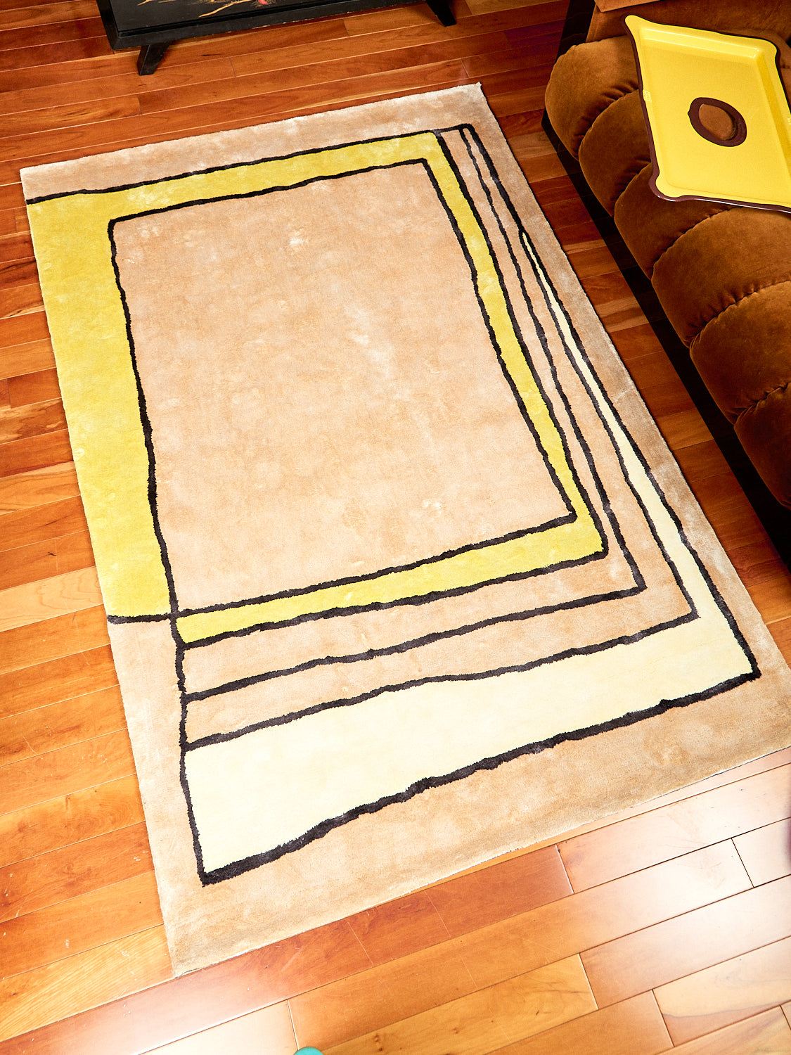 Time Frame Rug by Cold Picnic displayed on a hardwood floor.