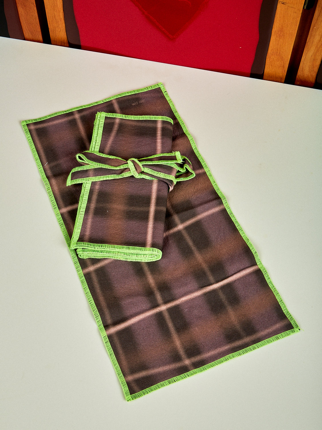 Single picture of Airbrush napkins showing brown and lime green. They are airbrushed in a grid shape. 