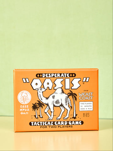 Card game box titled 'Oasis' with a camel illustration on an orange background.