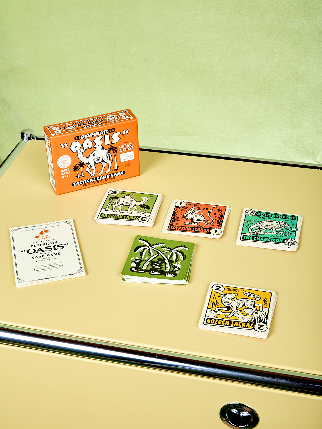 Collection of playing cards with a box on a beige surface