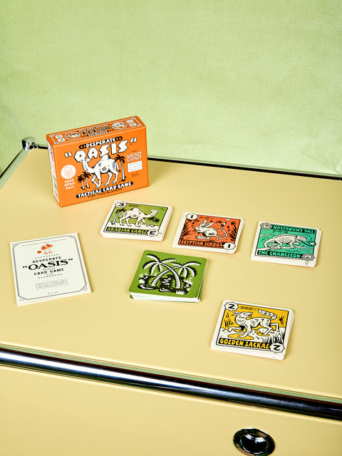 Collection of playing cards with a box on a beige surface