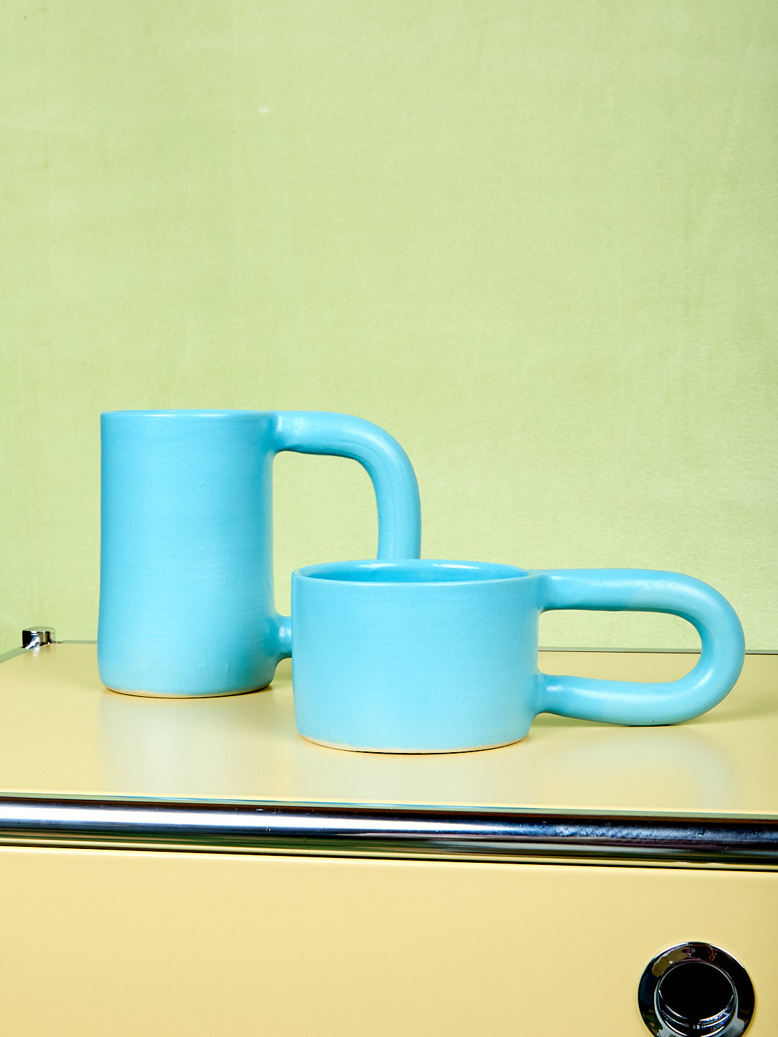 Blue tall and short stoneware mugs by Workaday Handmade