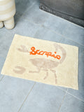 Bathmat with 'Scorpio' design on a tiled floor