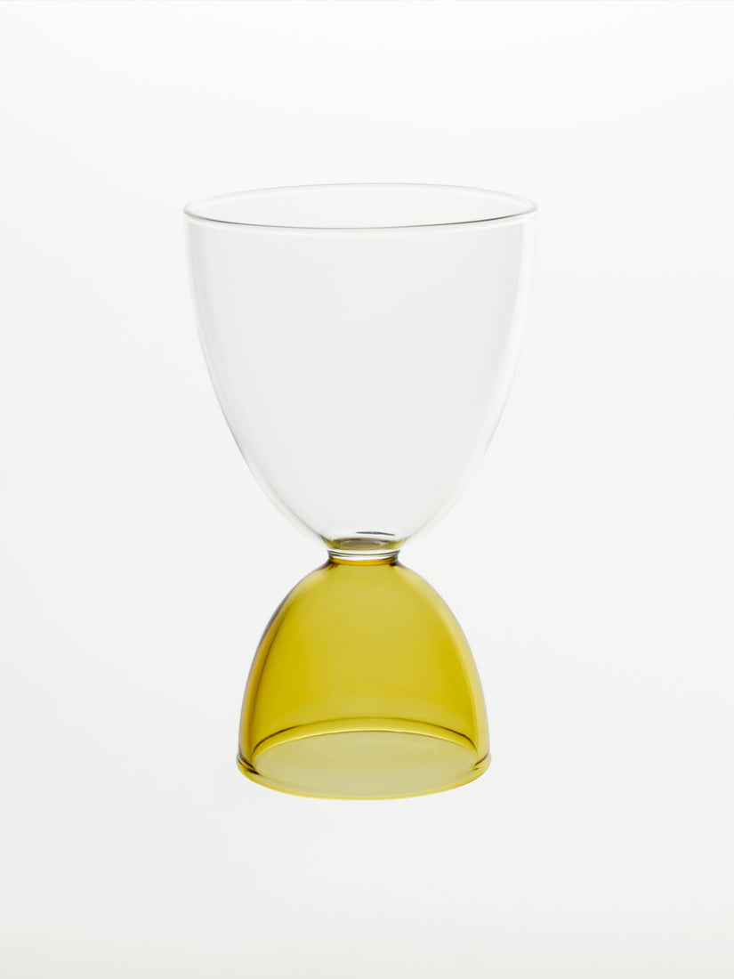 A clear top honey bottom cocktail glass.