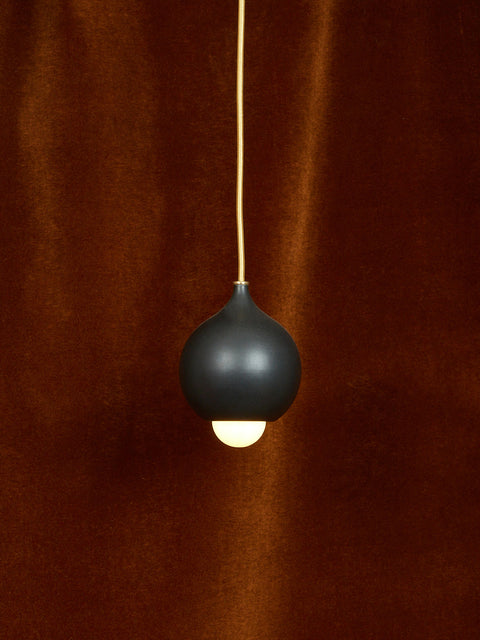 A matte black droplet pendant.