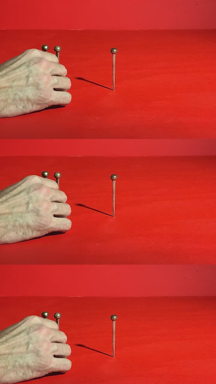 A video collage of hammering Hester the Nails into a red board.