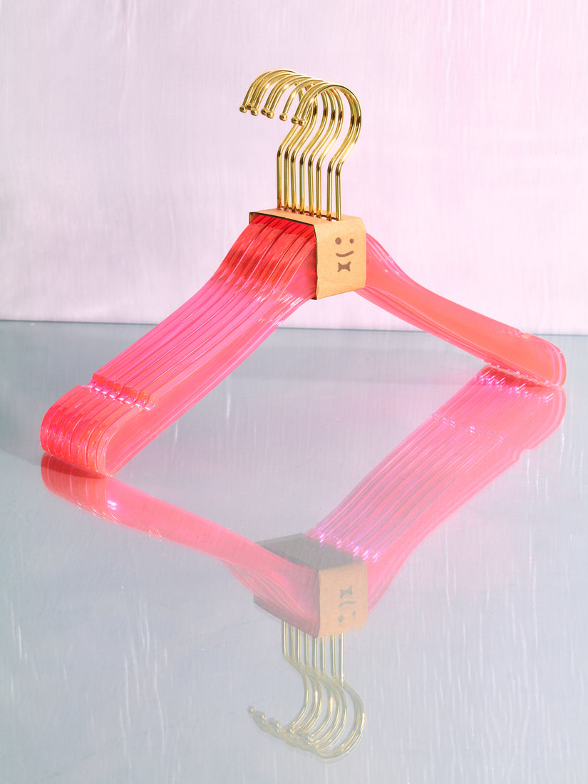 A pink set of hangers by Staff.