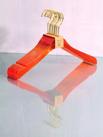 An orange set of hangers by Staff.