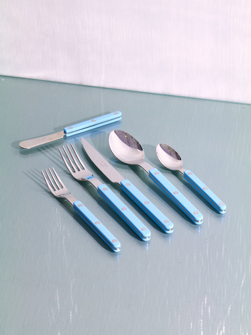 Six pieces of Sabre flatware in pastel blue and shiny finish.