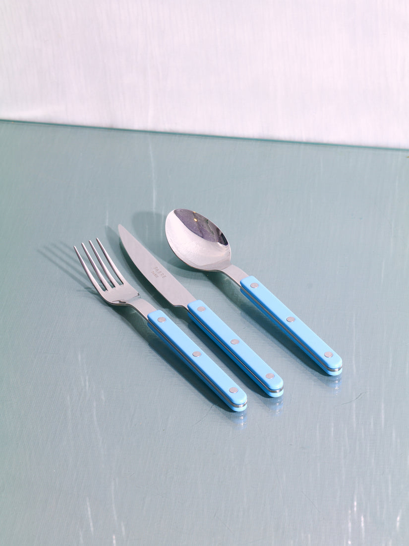 A dinner fork, knife, and spoon in Sabre's pastel blue colorway.